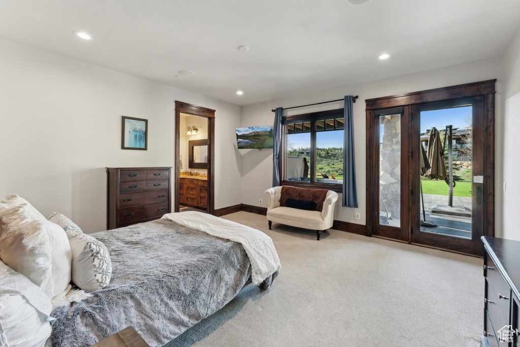 Bedroom featuring access to exterior, light colored carpet, recessed lighting, baseboards, and ensuite bathroom