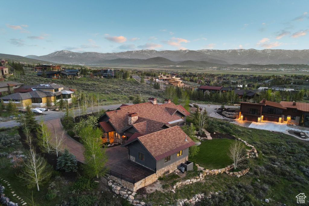 Aerial overview of property's location with mountains and nearby suburban area