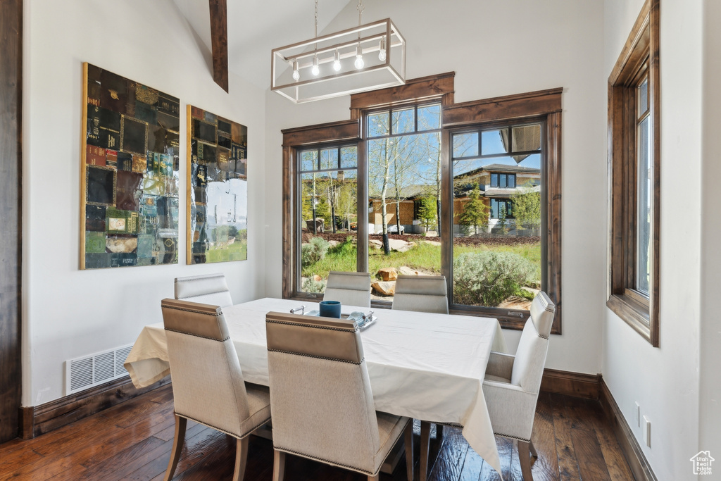 Dining room with dark wood-style floors and baseboards