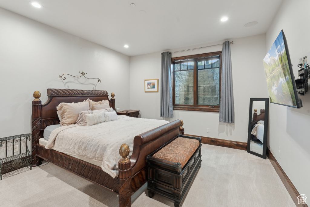 Bedroom featuring light colored carpet, recessed lighting, and baseboards