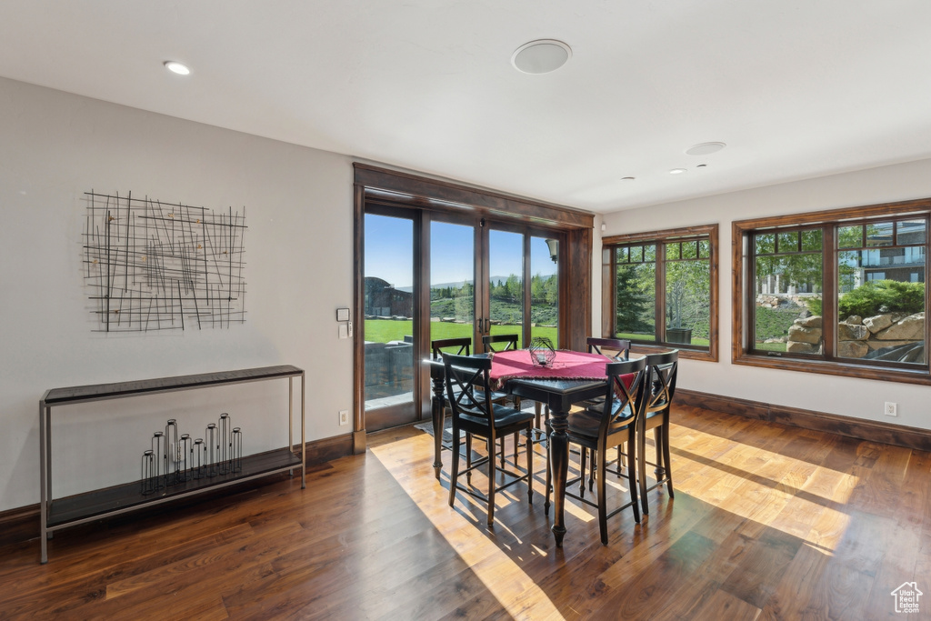 Dining room with plenty of natural light, wood finished floors, baseboards, and recessed lighting