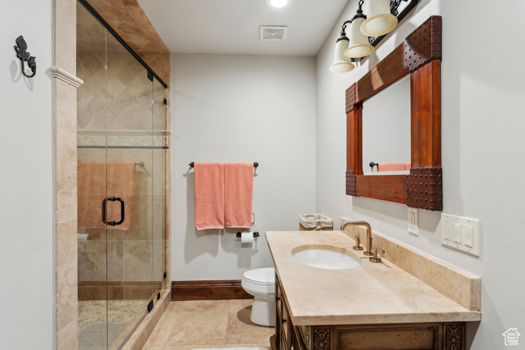 Full bath with baseboards, vanity, toilet, and a shower stall