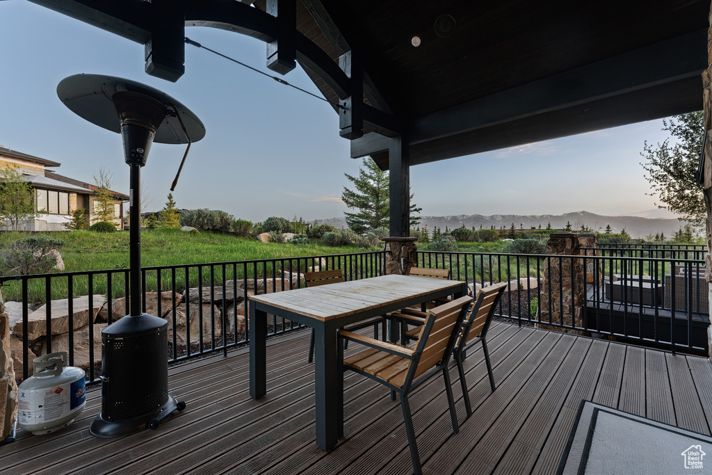 Deck featuring a mountain view and outdoor dining space