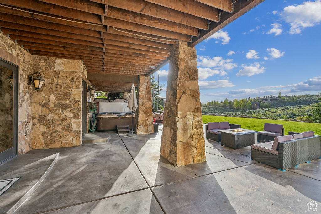 View of patio featuring an outdoor living space with a fire pit and an outdoor kitchen