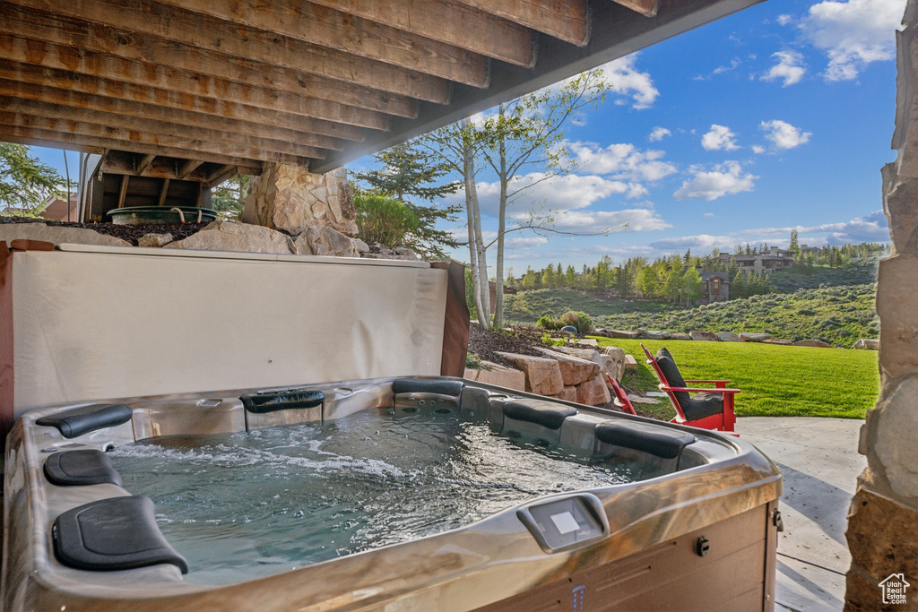 View of patio with a hot tub