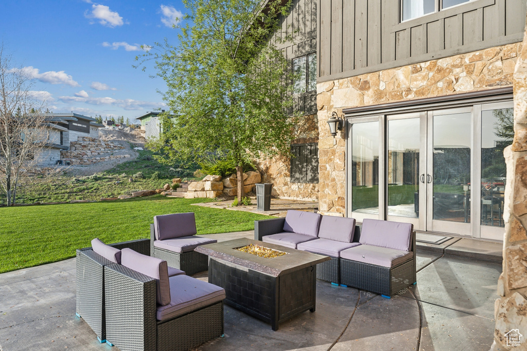 View of patio / terrace with french doors and an outdoor living space with a fire pit