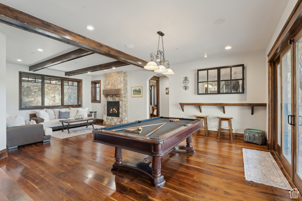 Recreation room with arched walkways, wood finished floors, recessed lighting, a fireplace, and pool table