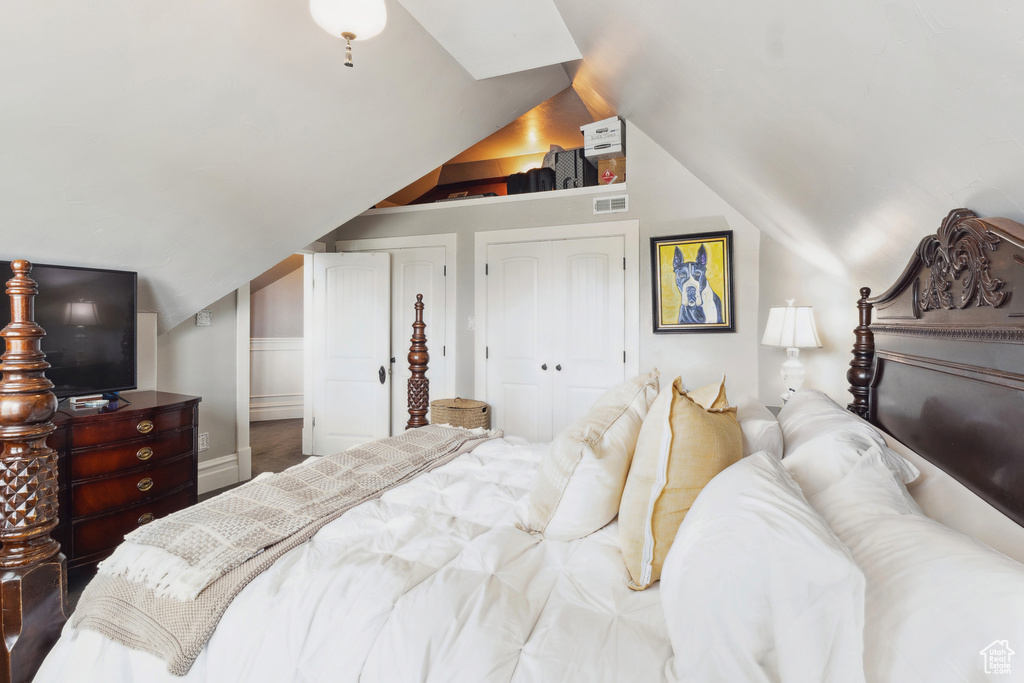 Bedroom featuring visible vents and lofted ceiling