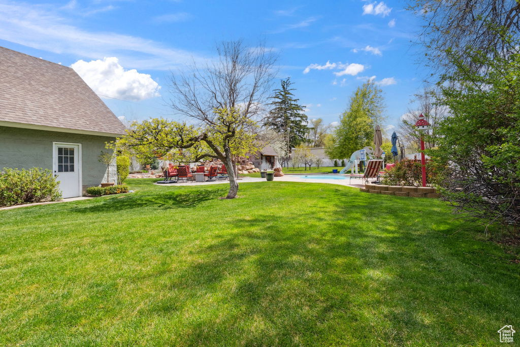 View of yard featuring a patio and a fenced in pool