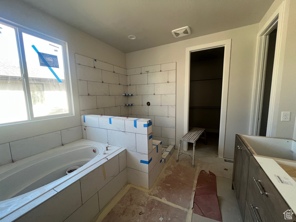 Full bathroom featuring vanity, a garden tub, and visible vents