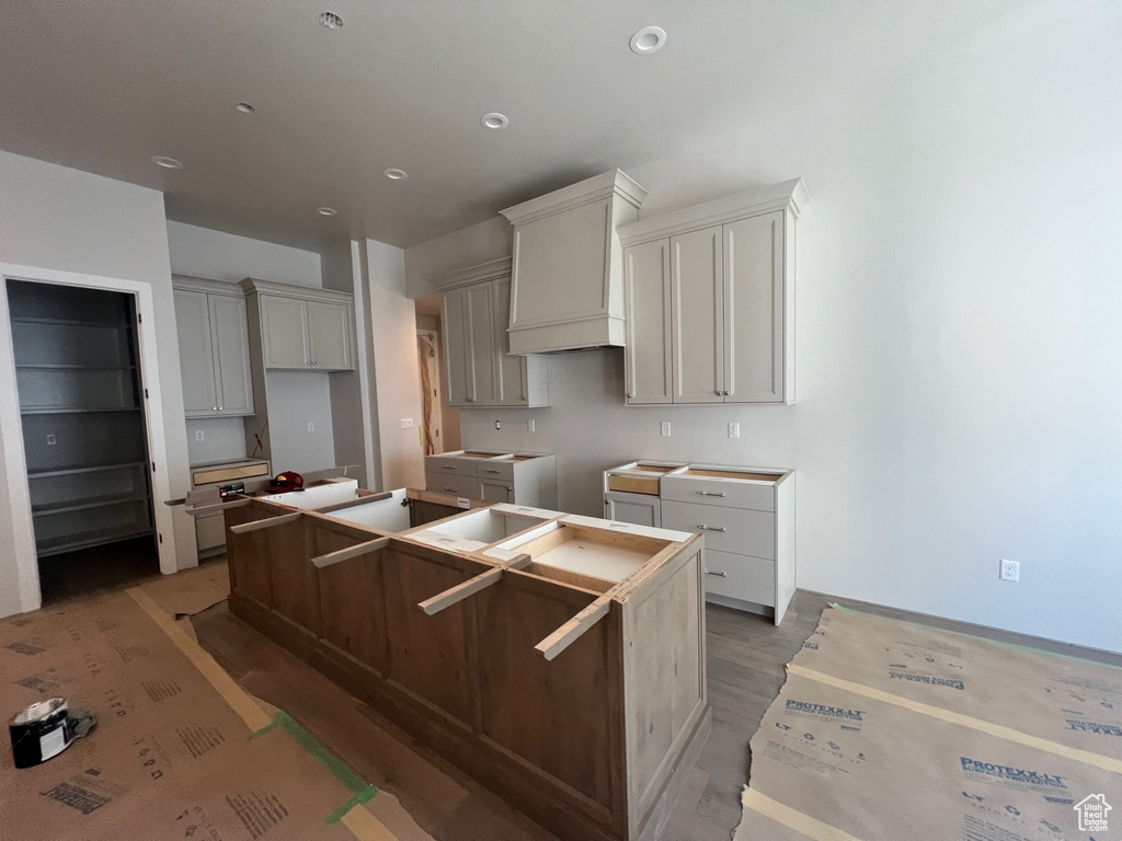 Kitchen featuring wood finished floors and a kitchen island