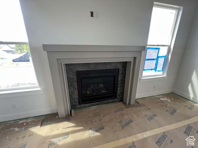 Interior details with a fireplace with flush hearth and baseboards