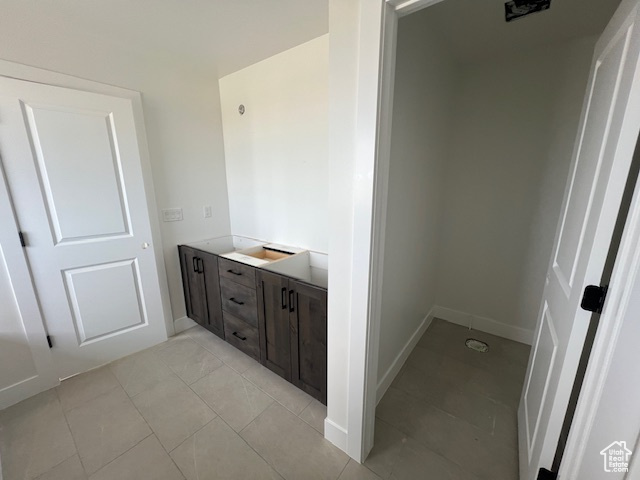 Bathroom featuring baseboards and tile patterned flooring