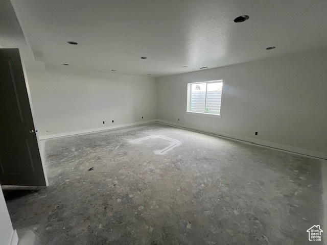 Spare room featuring baseboards