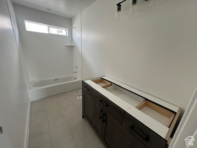 Full bath with shower / bathtub combination and tile patterned floors