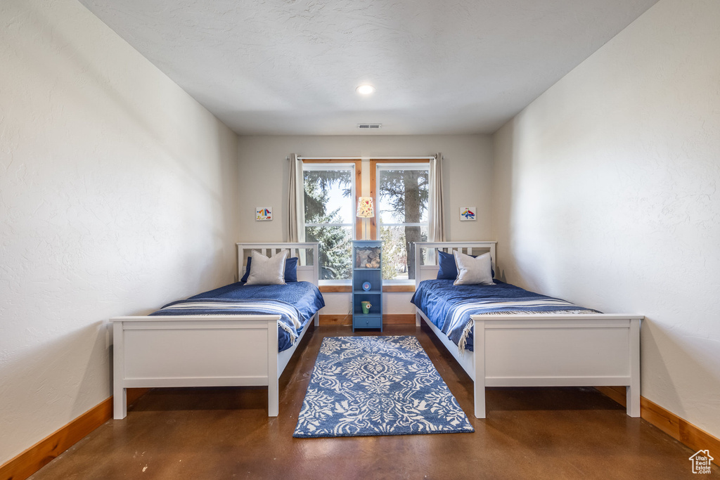 Bedroom with baseboards and visible vents