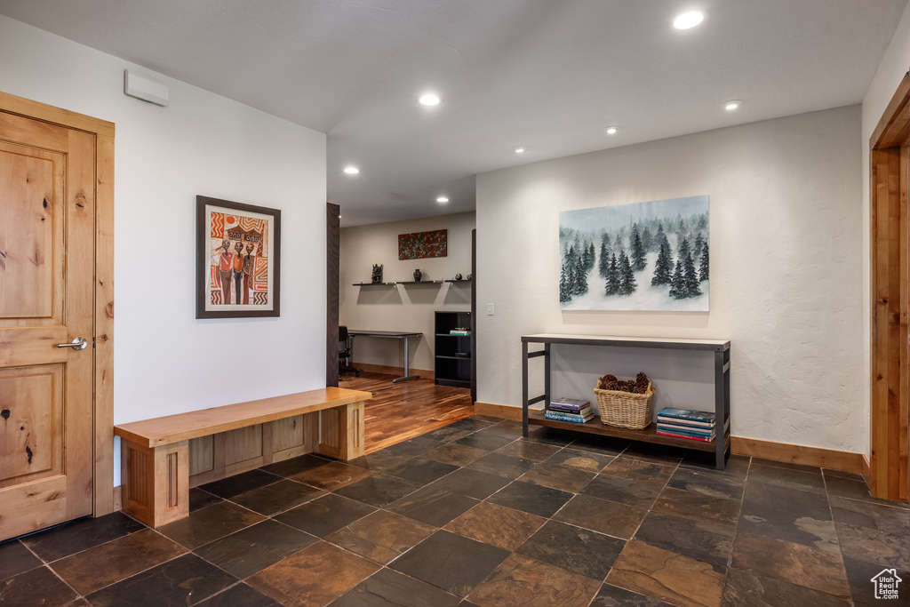 Interior space featuring recessed lighting, stone tile floors, and baseboards