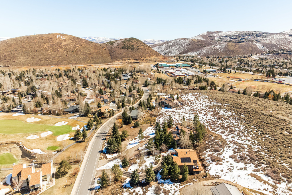 Aerial view with view of golf course and a mountain view