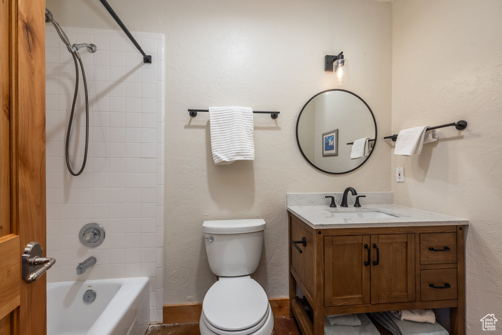 Bathroom with toilet, shower / bath combination, and vanity