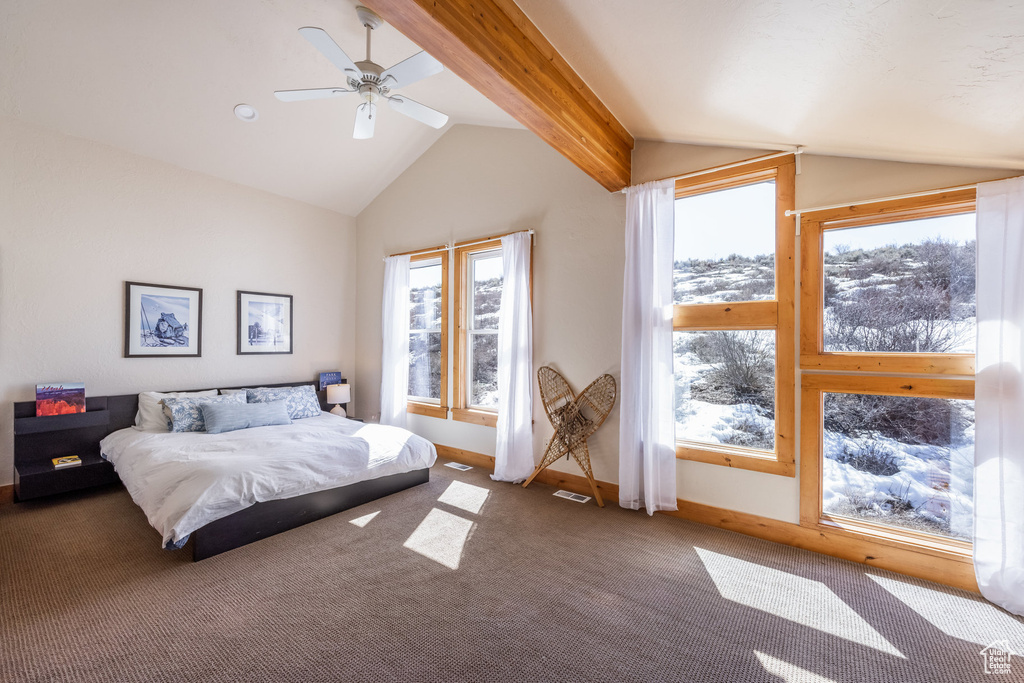 Bedroom featuring vaulted ceiling with beams, multiple windows, carpet flooring, and visible vents