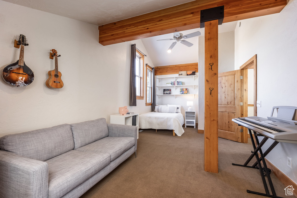 Bedroom with lofted ceiling with beams and carpet