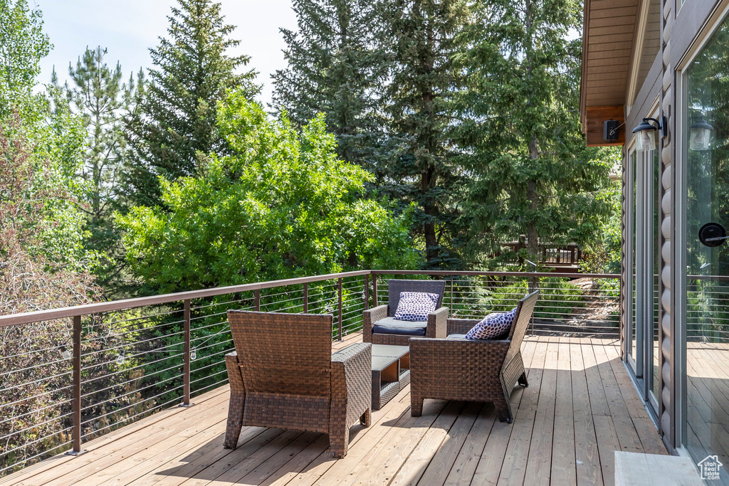Wooden terrace featuring outdoor lounge area
