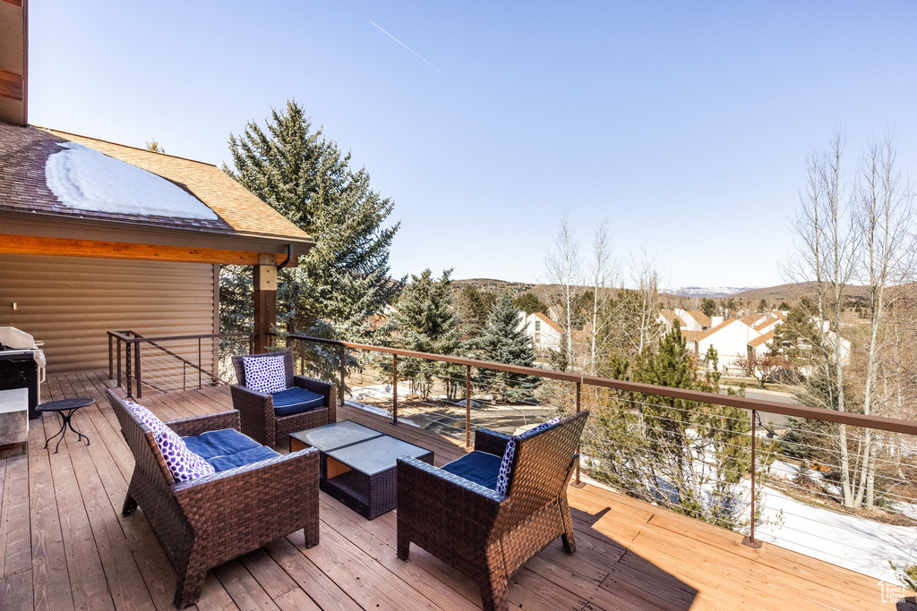 Wooden terrace featuring an outdoor hangout area