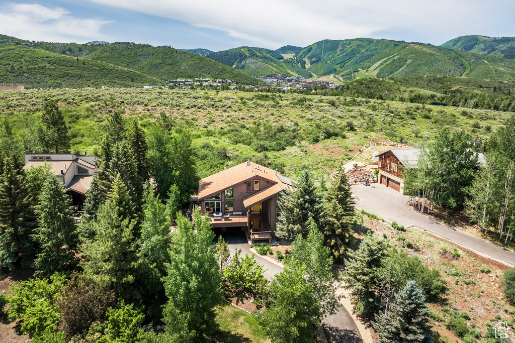 Aerial view of property and surrounding area with mountains