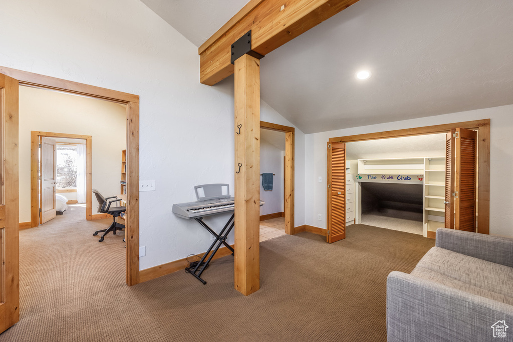 Corridor featuring carpet floors, vaulted ceiling with beams, and baseboards