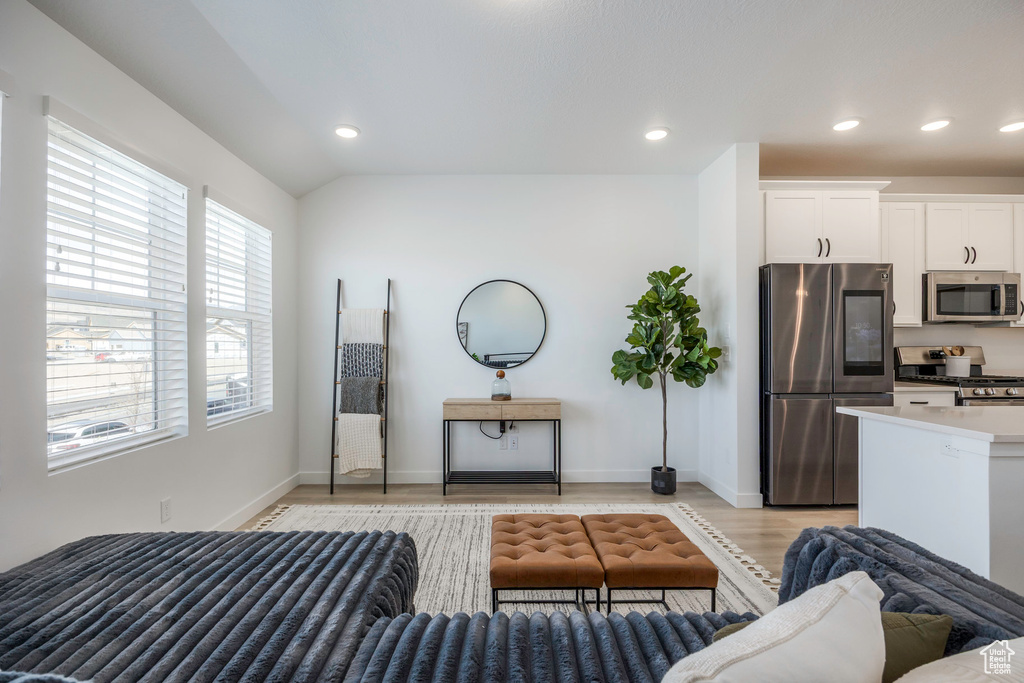 Living area with baseboards, light wood-style floors, and recessed lighting