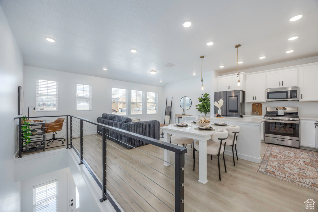 Kitchen featuring a healthy amount of sunlight, light countertops, stainless steel appliances, and light wood-style floors