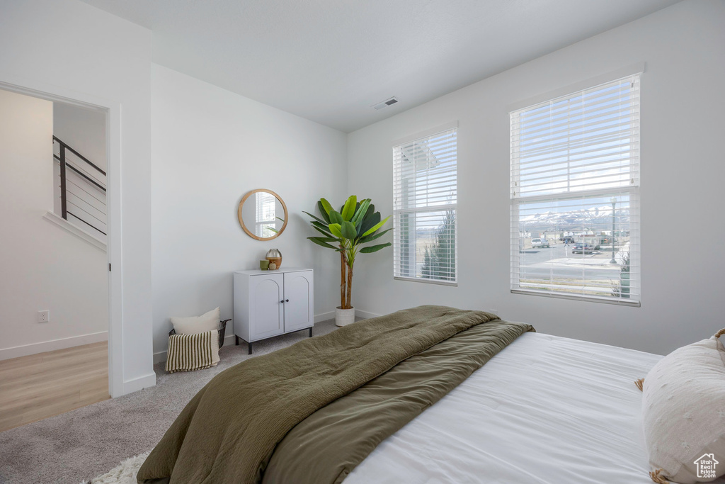 Bedroom featuring baseboards, visible vents, and carpet