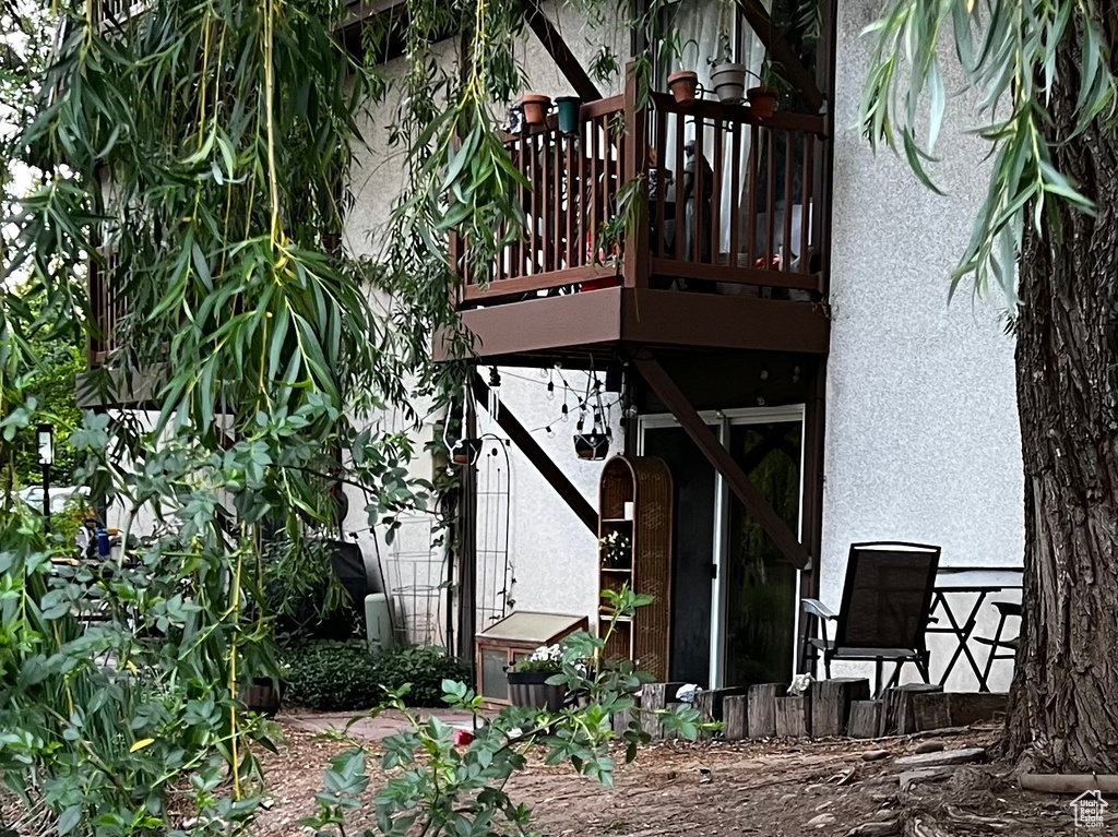 Back of house with stucco siding and a deck