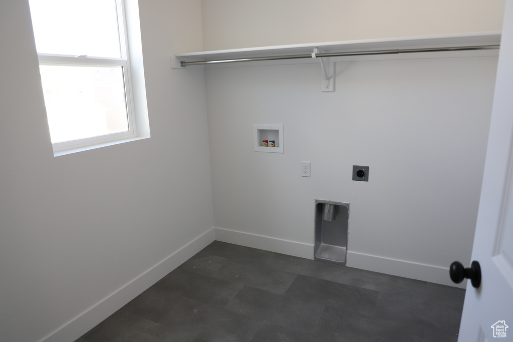 Laundry area featuring baseboards, hookup for an electric dryer, washer hookup, and laundry area