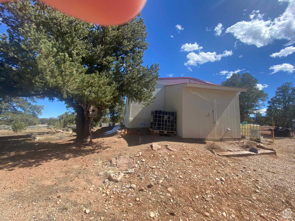 View of side of home with an outbuilding and cooling unit