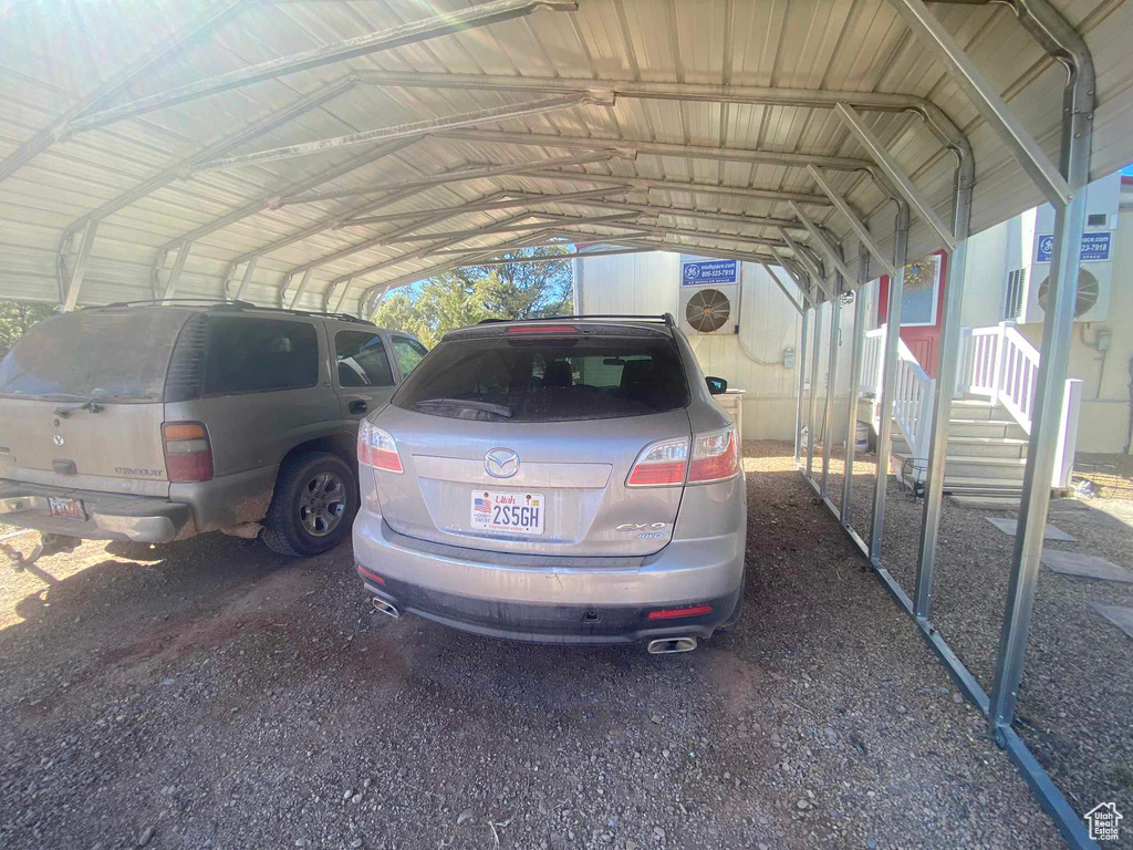 View of parking / parking lot with a carport