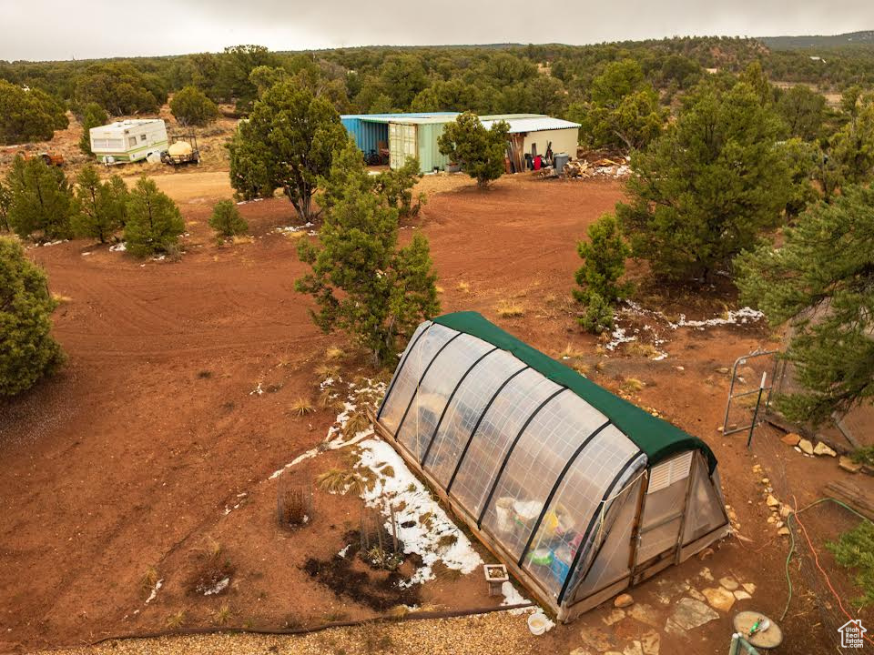 Aerial view featuring a wooded view