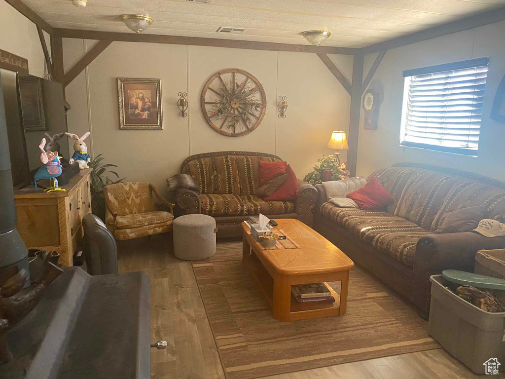 Living room with visible vents and light wood-style floors