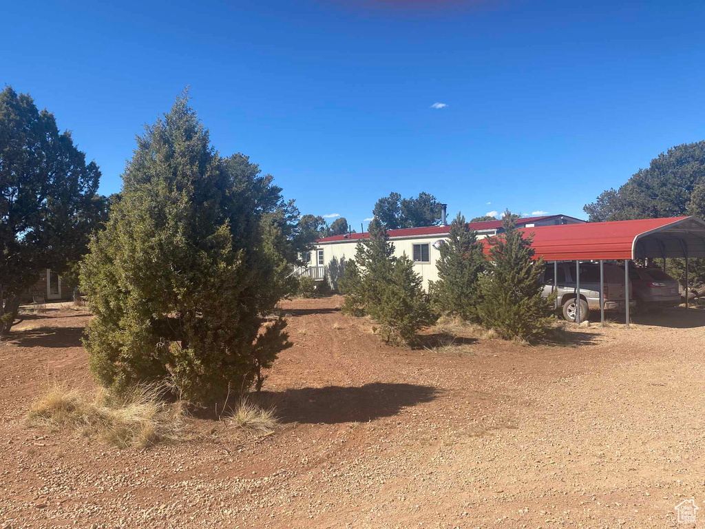 View of yard with a detached carport