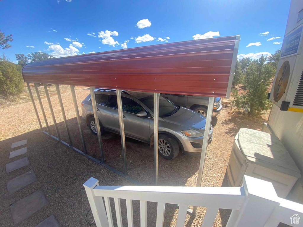 View of parking / parking lot with a detached carport