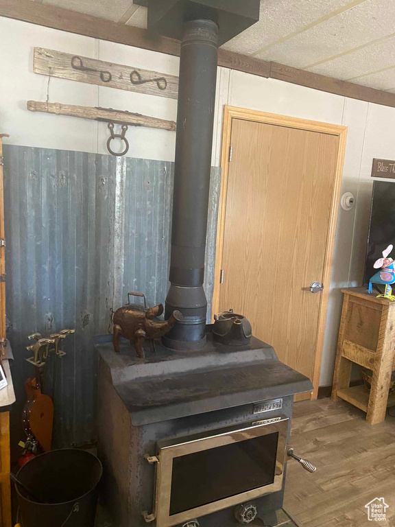 Interior details featuring wood finished floors and a wood stove