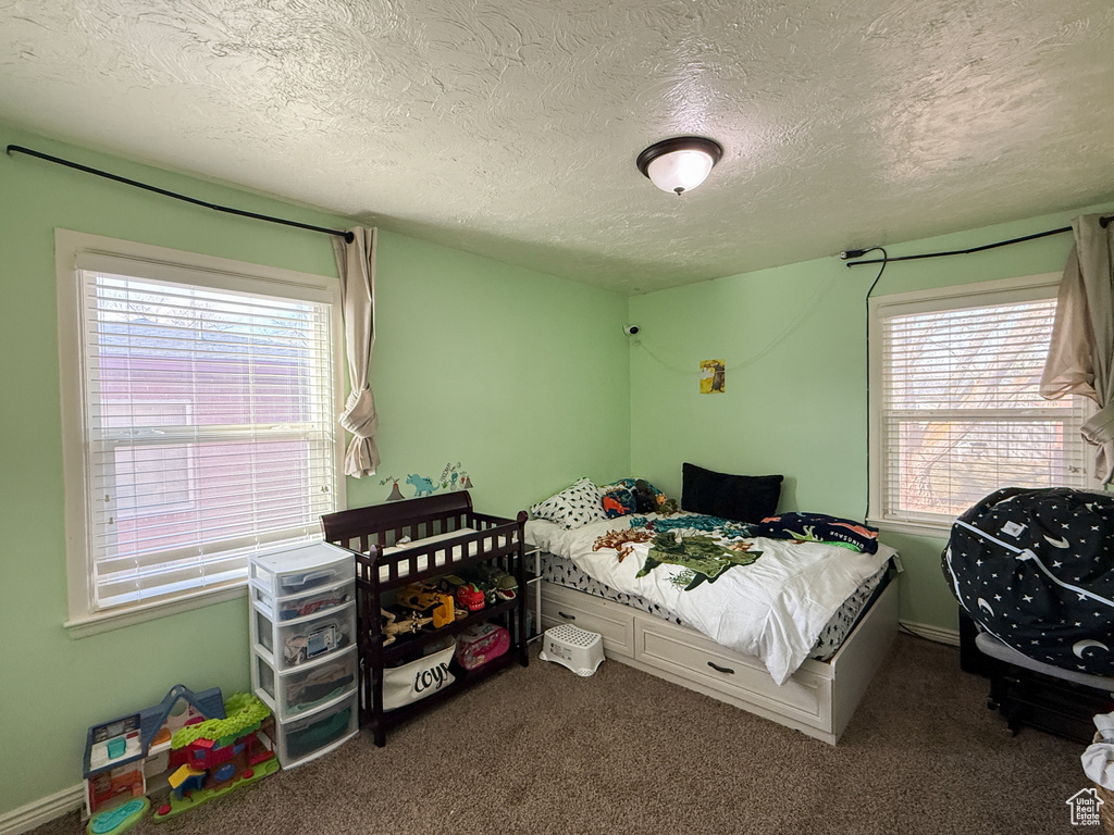 Carpeted bedroom with a textured ceiling
