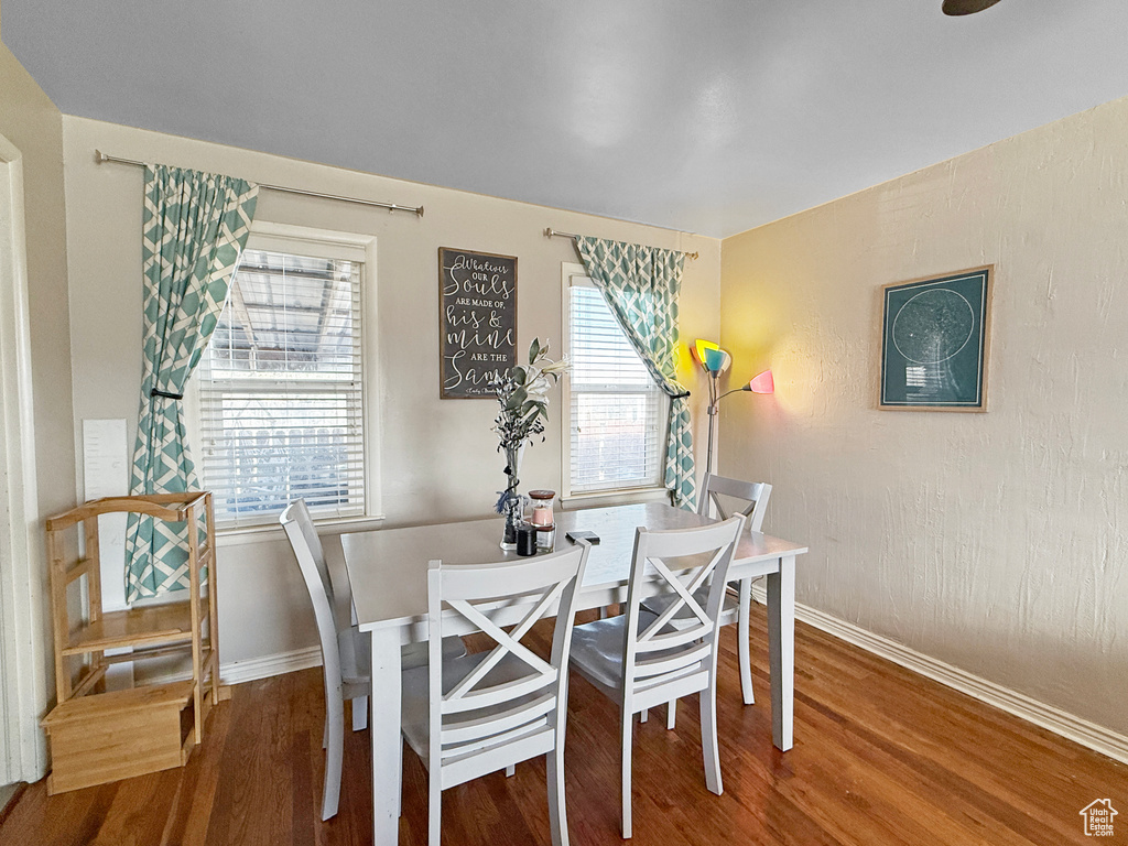 Dining space featuring baseboards and wood finished floors
