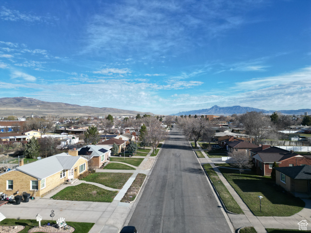 View of road featuring sidewalks, a residential view, a mountain view, and curbs