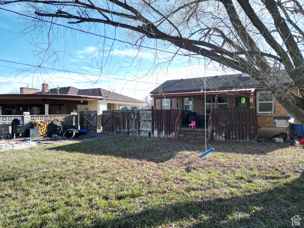 View of yard with a gate and fence
