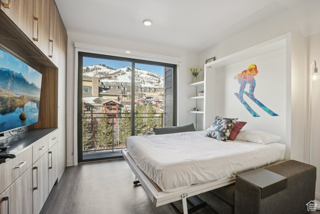 Bedroom featuring access to exterior and wood finished floors