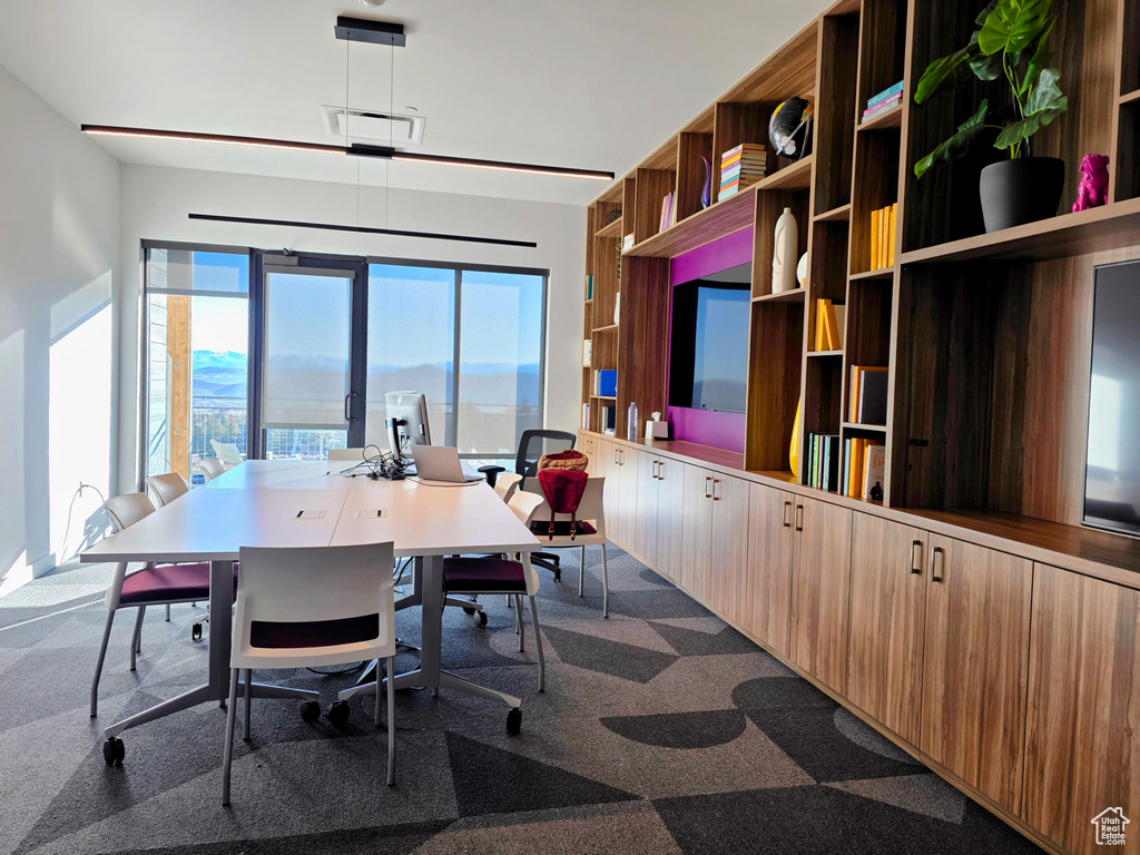 Home office featuring dark colored carpet and visible vents