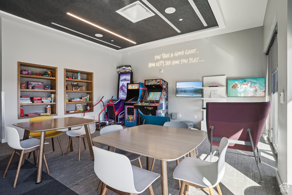 Interior space featuring built in features and a tray ceiling