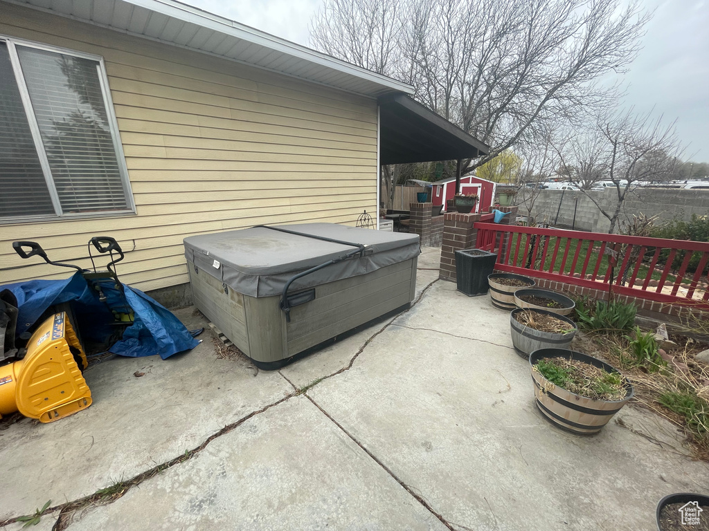 View of patio / terrace featuring central AC and a hot tub