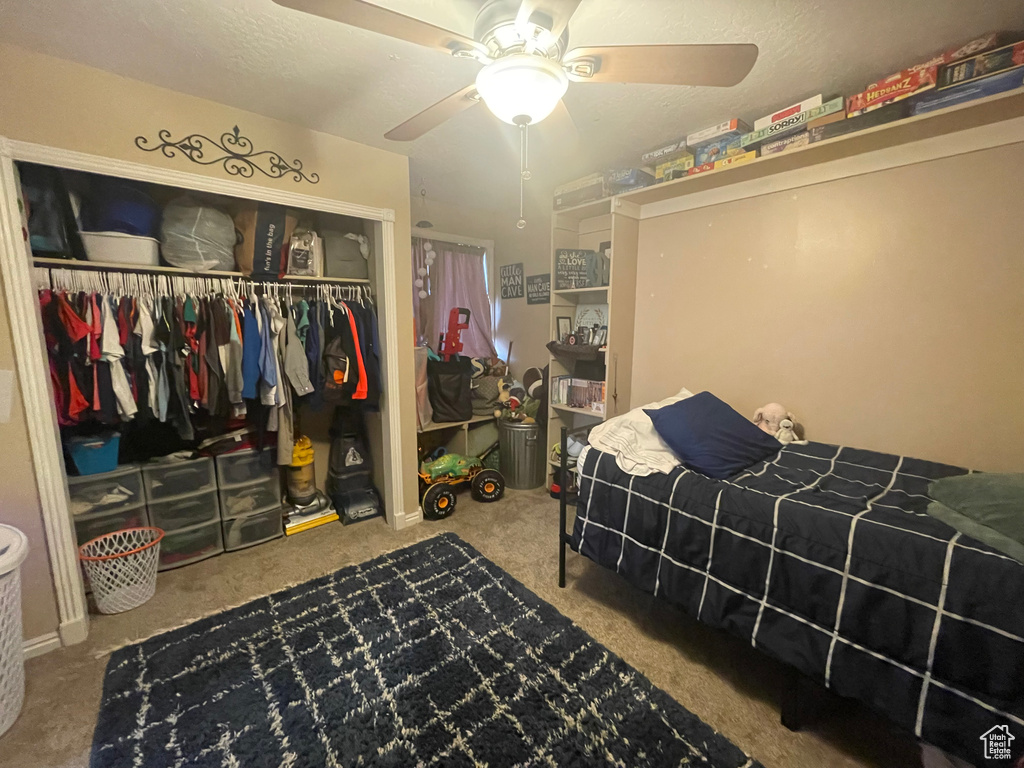 Bedroom featuring carpet floors, a closet, and ceiling fan